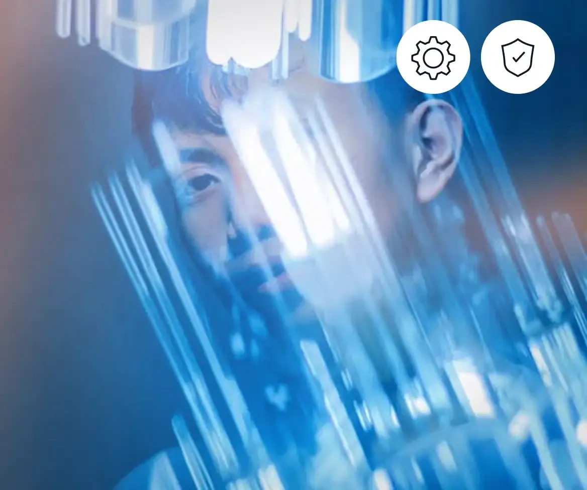 Engineer in front of a blue-lit data reflection with icons for configuration and security, representing IT and security roles.